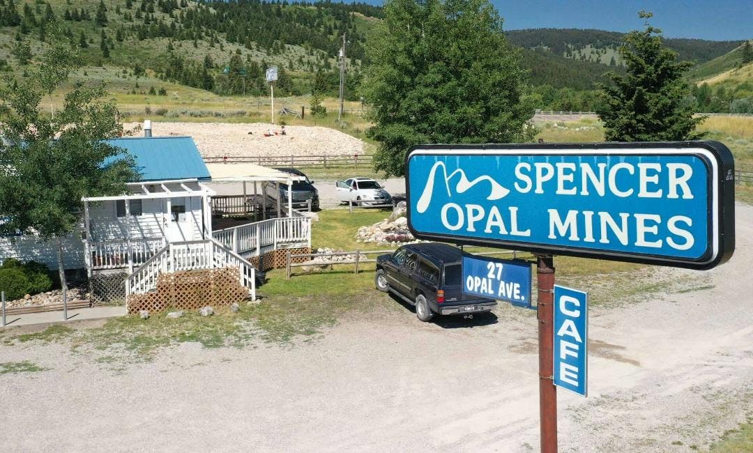 Outside view the Spencer Opal Mines cafe. With a sign that says "Spencer Opal Mines", "27 Opal Ave.", and "Cafe".