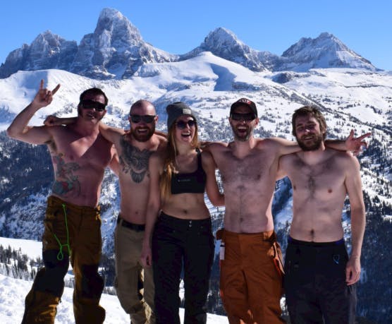 Spring breakers stand topless in front of the Teton Mountains at Grand Targhee Ski Resort in Yellowstone Teton Territory.