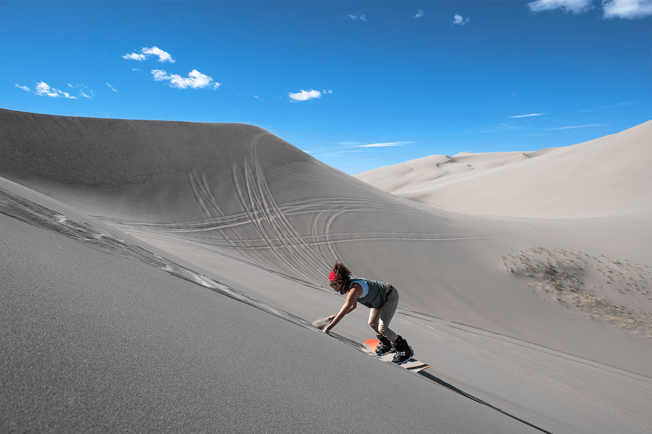A sandboarder on the St. Anthony Dunes in Yellowstone Teton Territory.