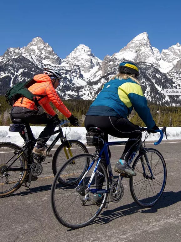 Bikers ride the road in Grand Teton National Park in Yellowstone Teton Territory.